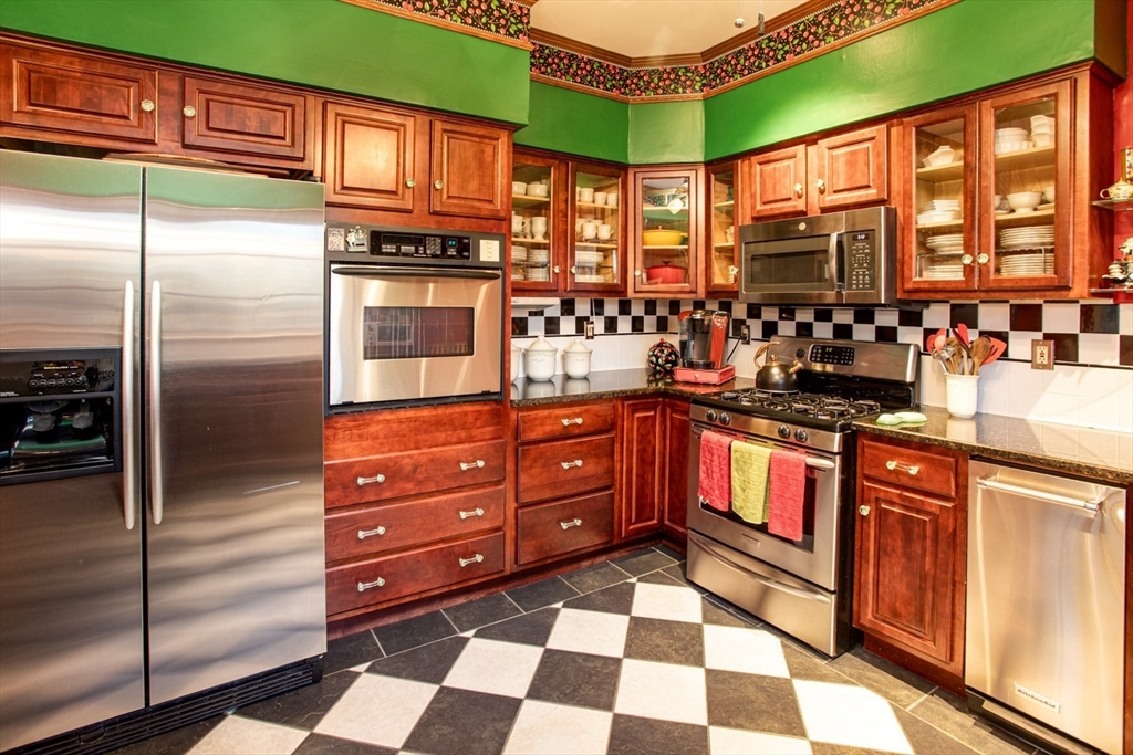 1231 Robeson Street Fall River, MA 02720 - Photo 9 of 39 a kitchen with stainless steel appliances granite countertop a refrigerator and a stove