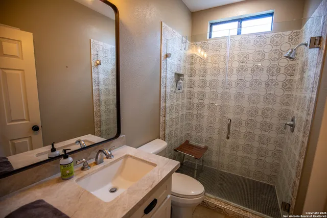 a bedroom with furniture and a lamp