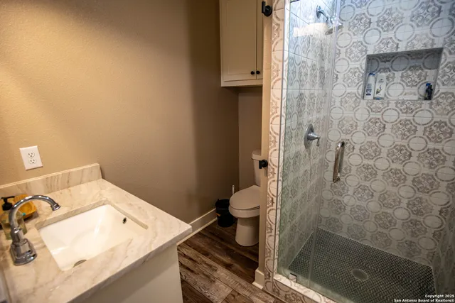 a spacious bedroom with a bed and wooden floor