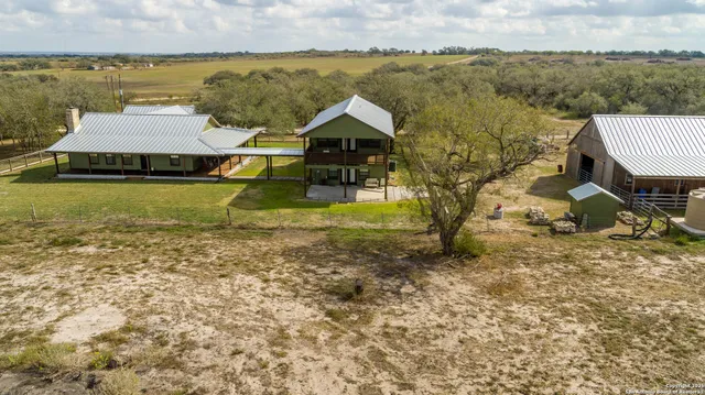 a aerial view of a house with big yard