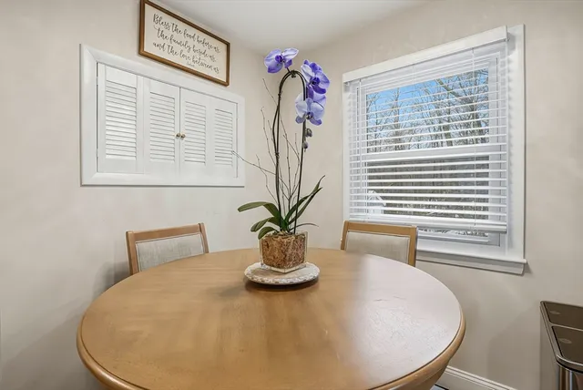 a view of a dining room with furniture and a window
