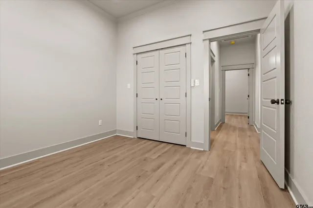 a view of a hallway with wooden floor