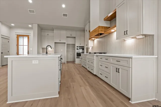 a kitchen with cabinets a sink and appliances