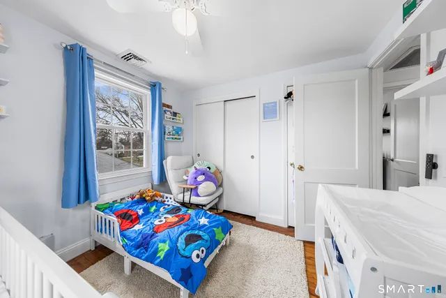 a bedroom with furniture and a wooden floor