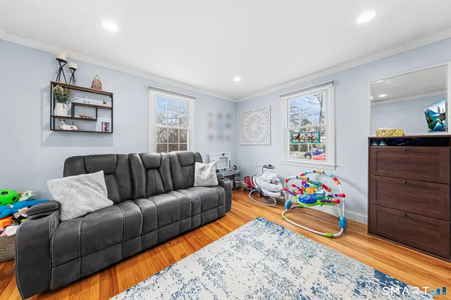 a living room with furniture and wooden floor