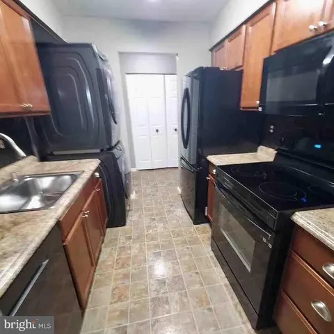 a kitchen with a refrigerator and a sink