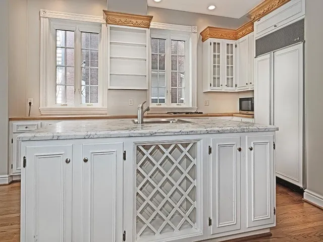 a kitchen with granite countertop a sink and dishwasher with wooden floor
