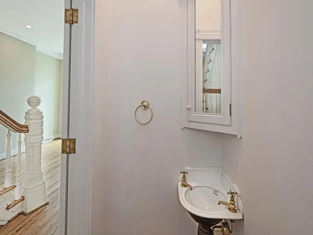 a bathroom with a sink a toilet and mirror