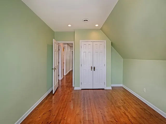 a view of hallway with wooden floor