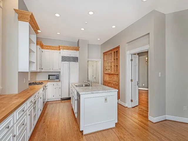 a kitchen with a stove a sink and a refrigerator