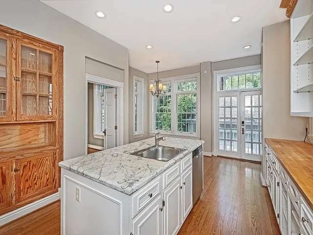 a kitchen with granite countertop sink stove and refrigerator