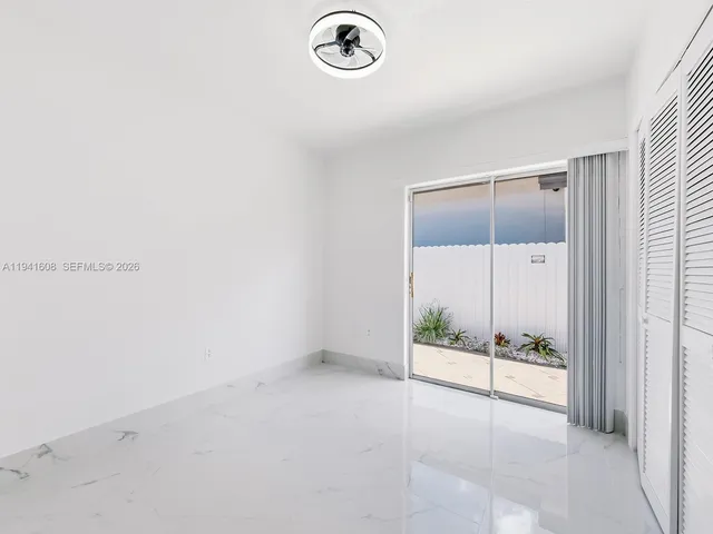 an empty room with sliding glass door
