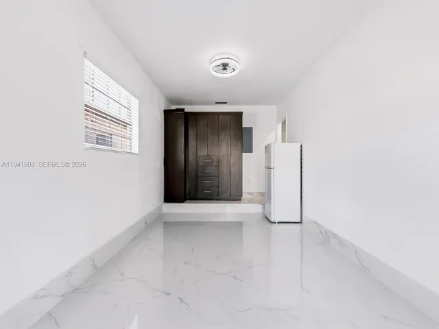 an empty room with a white door