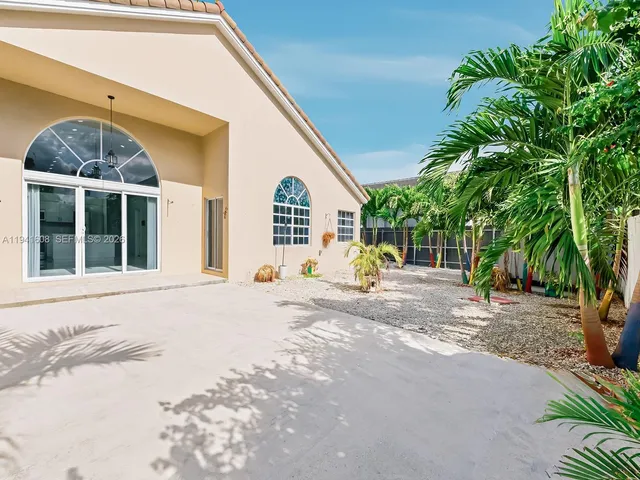 a view of a house with backyard and sitting area