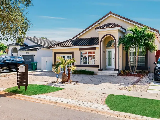 a view of house with outdoor space and parking