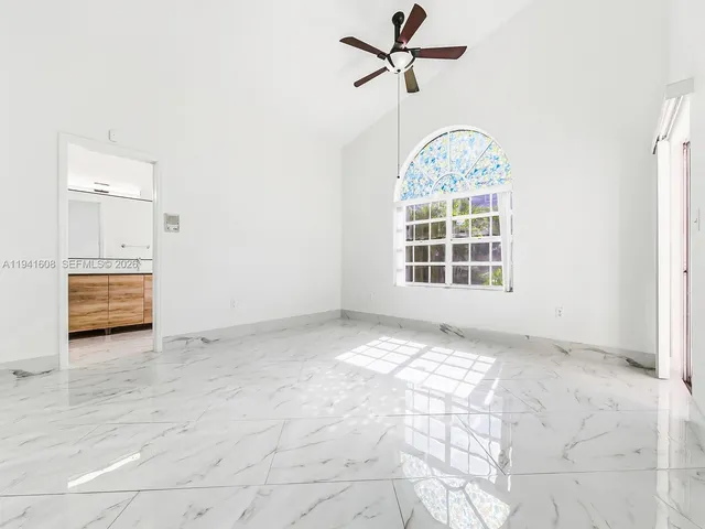 a view of an empty room with a window