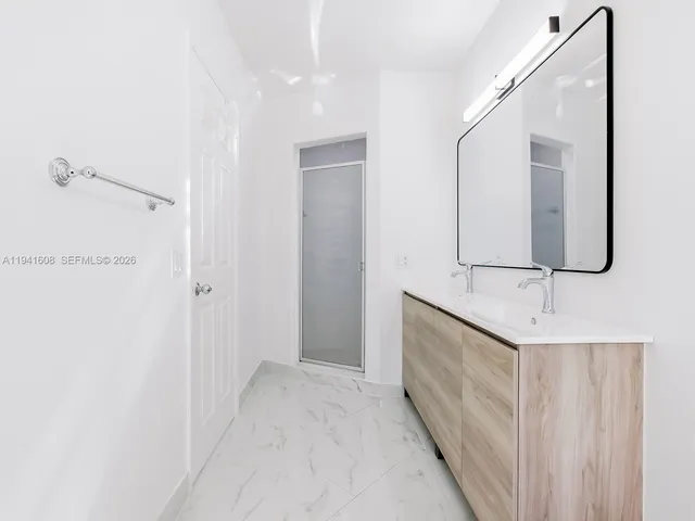 a bathroom with a double vanity sink and mirror