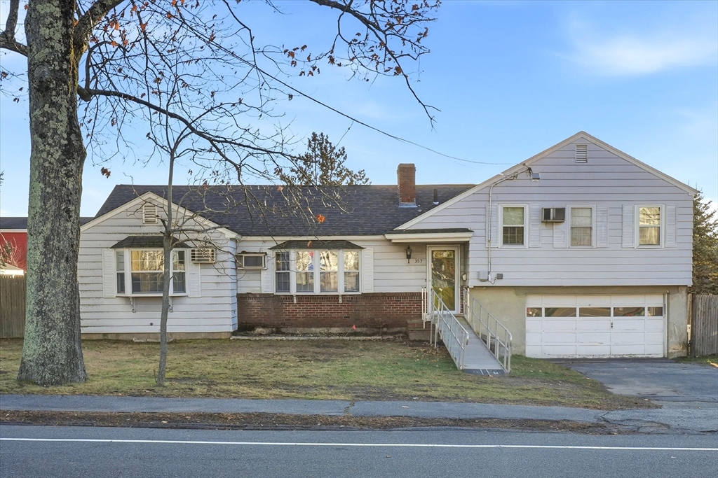 387 Massachusetts Avenue North Andover, MA 01845 - Photo 1 of 34 a front view of a house with a yard