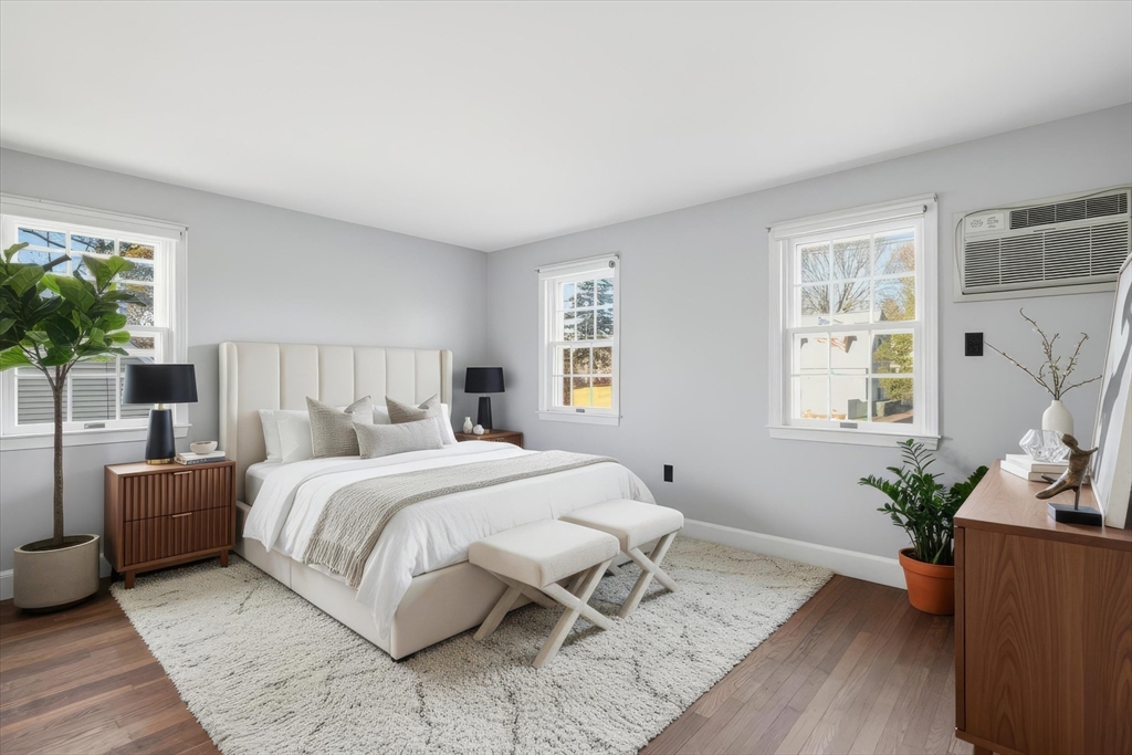 387 Massachusetts Avenue North Andover, MA 01845 - Photo 19 of 34 a bedroom with a bed and wooden floor
