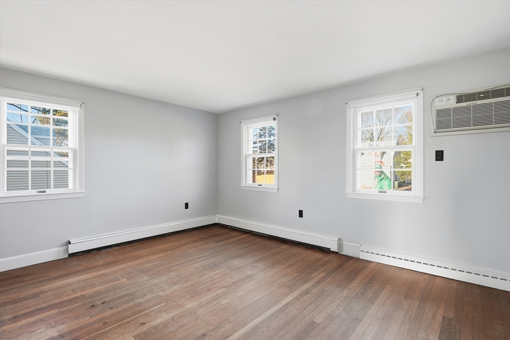 387 Massachusetts Avenue North Andover, MA 01845 - Photo 20 of 34 a view of an empty room with wooden floor and a window