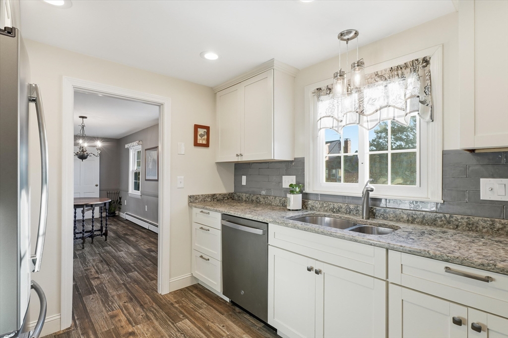 387 Massachusetts Avenue North Andover, MA 01845 - Photo 2 of 34 a kitchen with granite countertop a sink cabinets and window