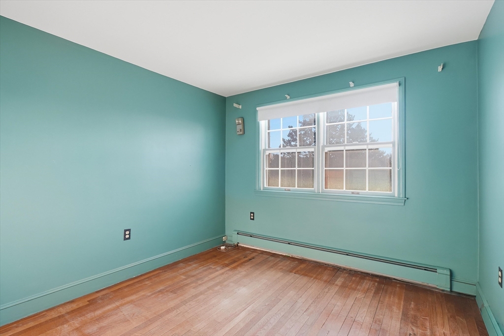 387 Massachusetts Avenue North Andover, MA 01845 - Photo 22 of 34 a view of empty room with wooden floor and fan