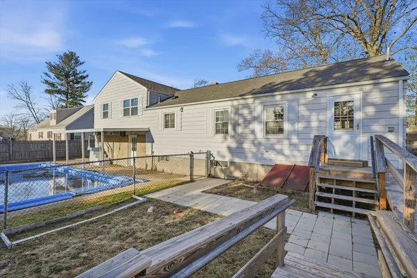 a view of a house with chairs and wooden floor