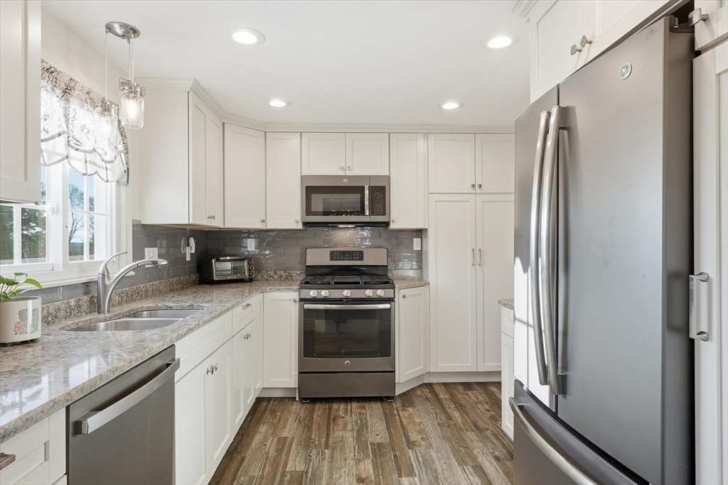 387 Massachusetts Avenue North Andover, MA 01845 - Photo 3 of 34 a kitchen with stainless steel appliances a refrigerator sink and microwave