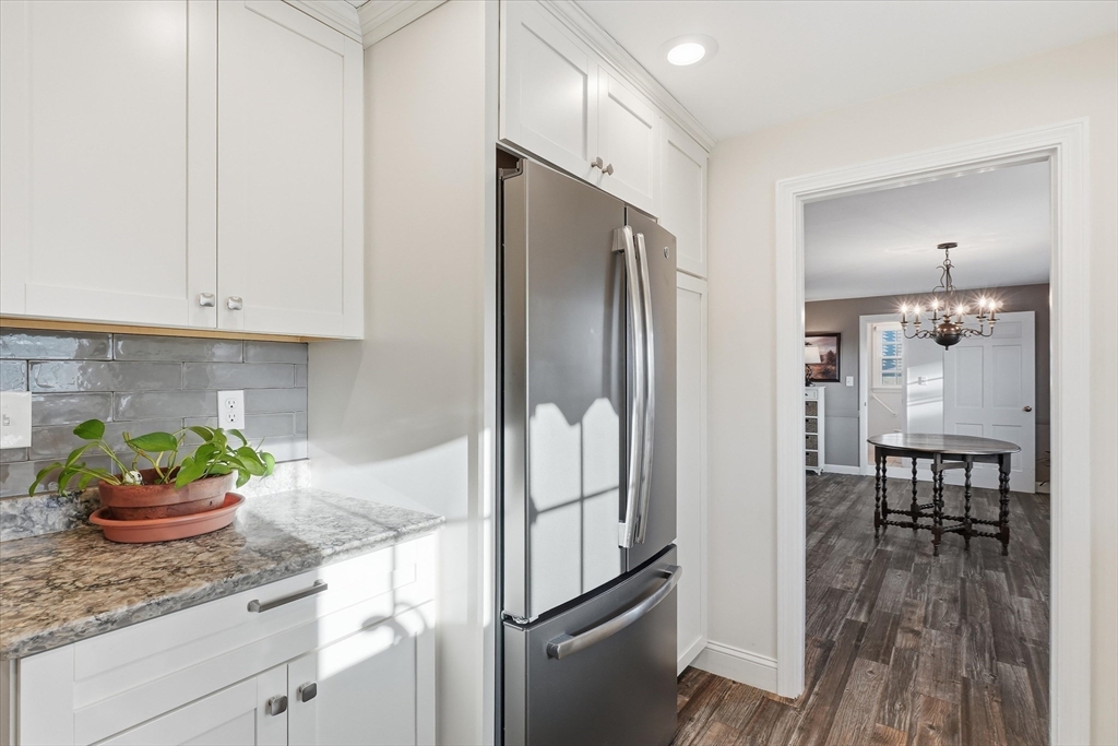 387 Massachusetts Avenue North Andover, MA 01845 - Photo 4 of 34 a kitchen with stainless steel appliances granite countertop a refrigerator and a white cabinets