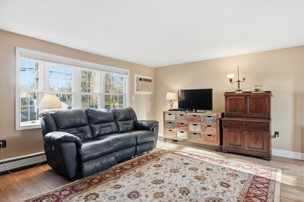 387 Massachusetts Avenue North Andover, MA 01845 - Photo 5 of 34 a living room with furniture and a flat screen tv