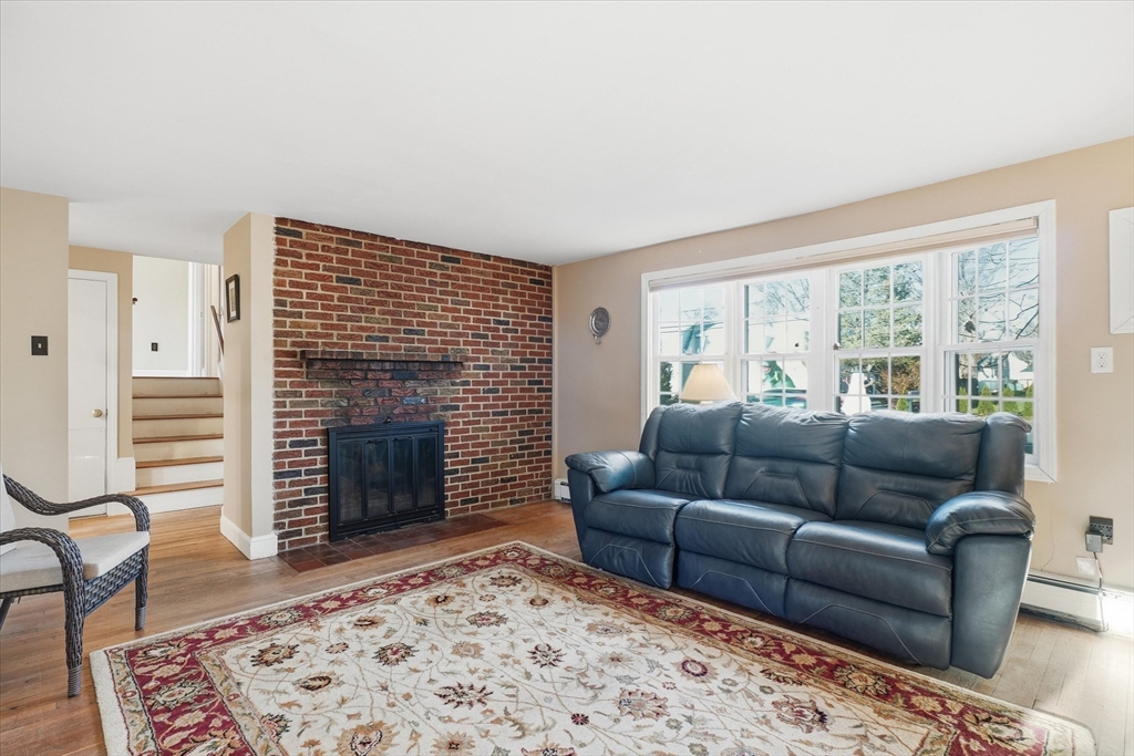 387 Massachusetts Avenue North Andover, MA 01845 - Photo 7 of 34 a living room with furniture and a fireplace