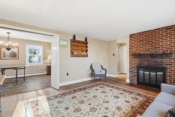 a living room with furniture a rug and a fireplace