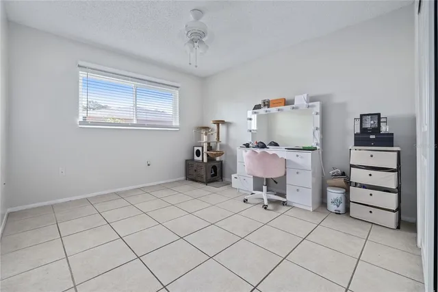 a bathroom with a granite countertop toilet sink and mirror