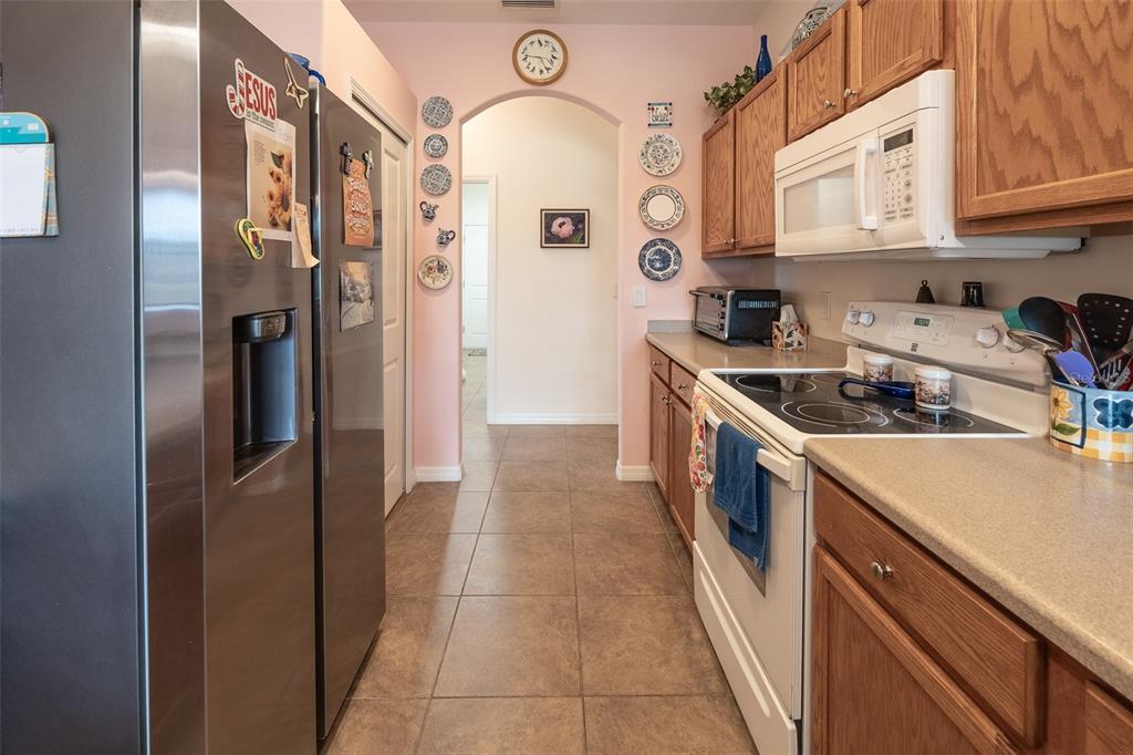 15969 Southwest 14th Avenue Road Ocala, FL 34473 - Photo 10 of 46 a kitchen with stainless steel appliances granite countertop a refrigerator and a stove