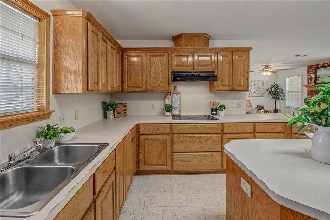 1110 County Road 439 Dime Box, TX 77853 - Photo 24 of 50 a kitchen with stainless steel appliances a sink a stove cabinets counter space and a window