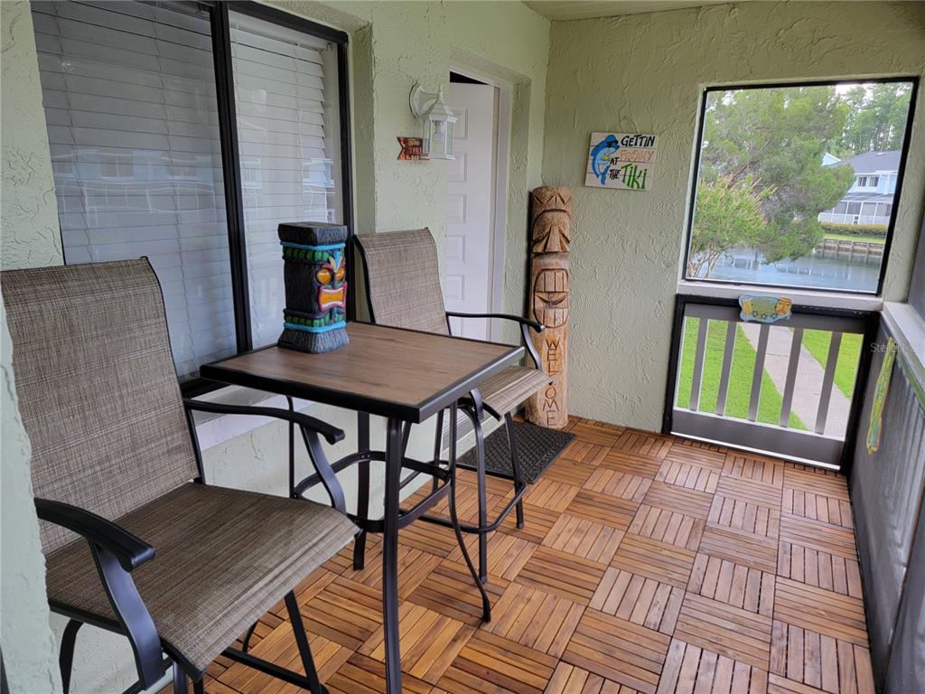 1865 Mazo Manor Road, Unit J2 Lutz, FL 33558 - Photo 3 of 12 a view of a dining room with furniture a chandelier and wooden floor