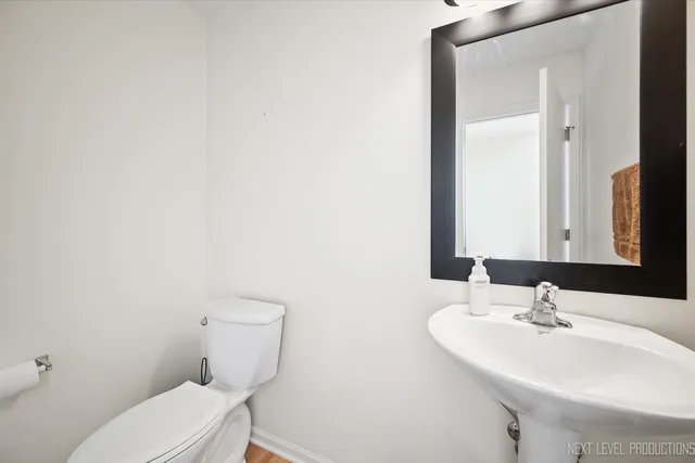 a view of a room with furniture and wooden floor