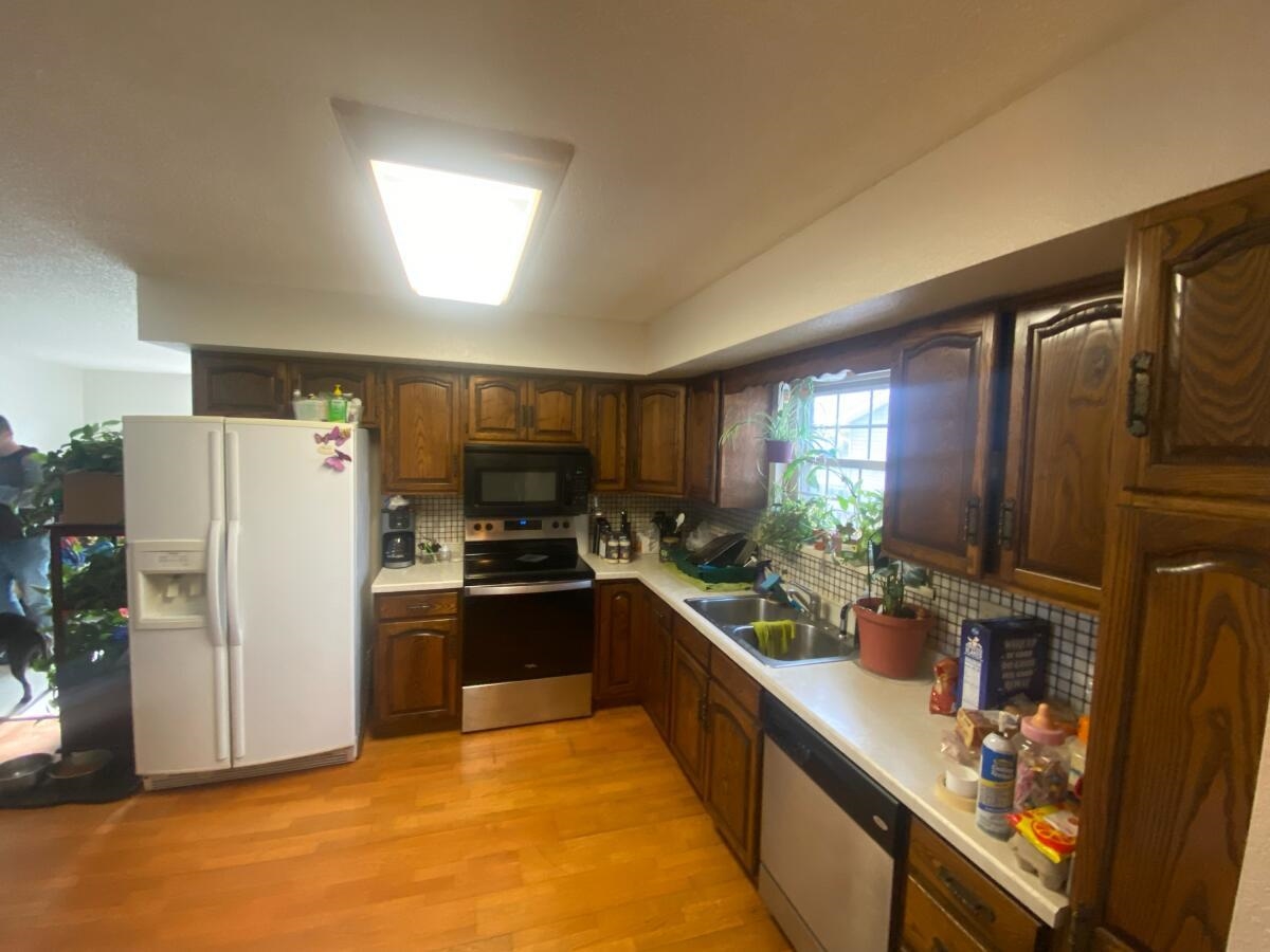 321 North Ash Street Fruita, CO 81521 - Photo 4 of 7 a kitchen with stainless steel appliances granite countertop a refrigerator a stove a sink and a refrigerator