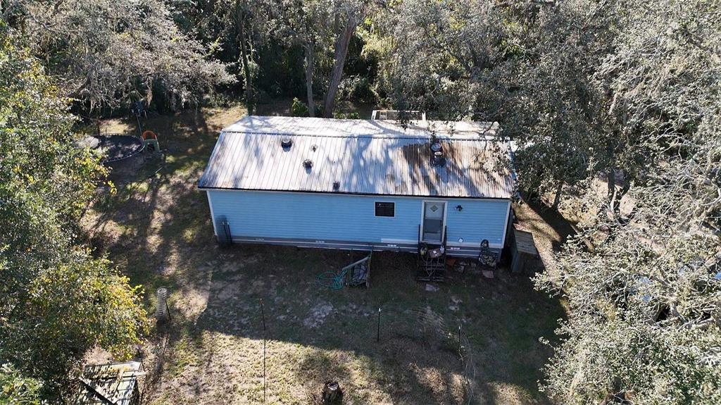 8735 Cr 631a Bushnell Bushnell, FL 33513 - Photo 13 of 17 a wooden bench sitting in the middle of a yard