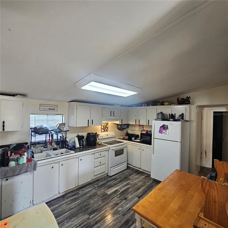 8735 Cr 631a Bushnell Bushnell, FL 33513 - Photo 17 of 17 a kitchen with a sink a refrigerator and cabinets