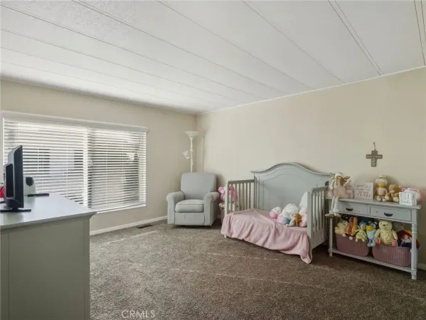 a bedroom with bed and a window
