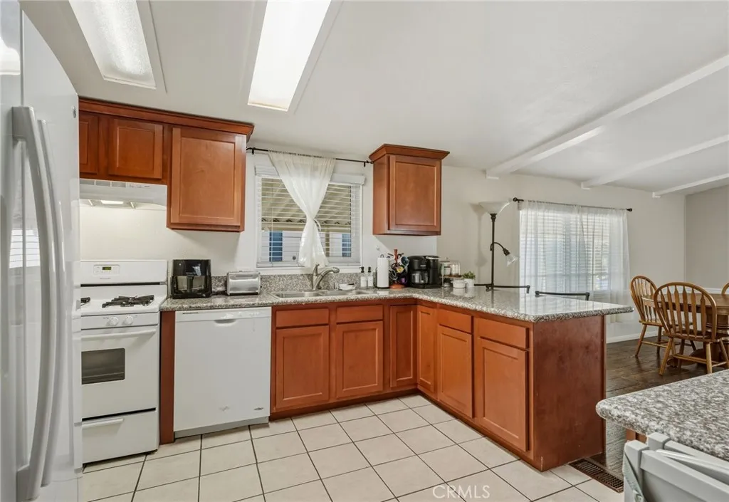 1051 Site, Unit 236 Brea, CA 92821 - Photo 2 of 19 a kitchen with stainless steel appliances granite countertop a sink and cabinets