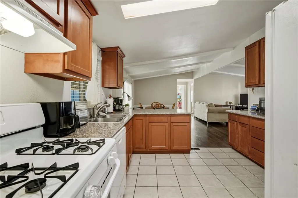 1051 Site, Unit 236 Brea, CA 92821 - Photo 3 of 19 a kitchen with stainless steel appliances granite countertop a stove and a sink