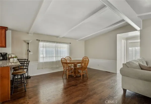 a dining room with furniture and wooden floor