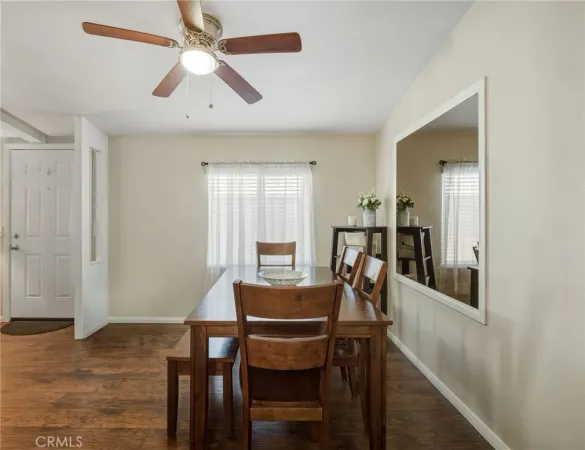 a view of a dining room with furniture and a chandelier fan