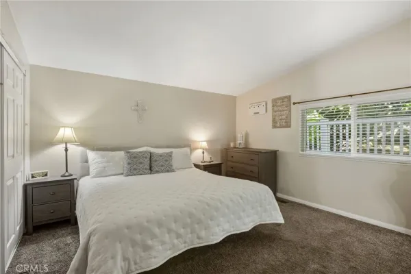 a bedroom with a bed and a night stand