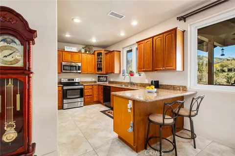 a bathroom with a granite countertop sink a mirror and a shower
