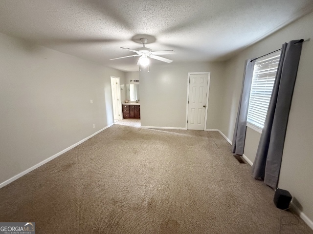 451 Lambs Bridge Road Swainsboro, GA 30401 - Photo 9 of 23 an empty room with windows and fan