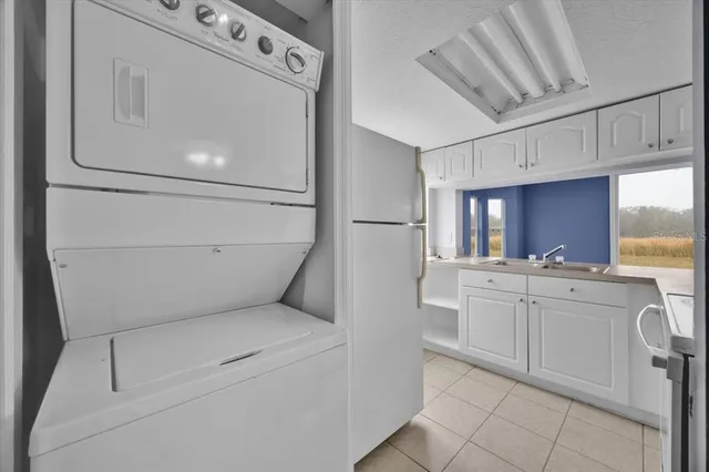 a utility room with cabinets washer and dryer