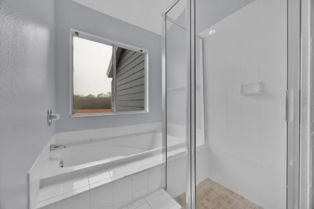 a bathroom with a bathtub and a shower